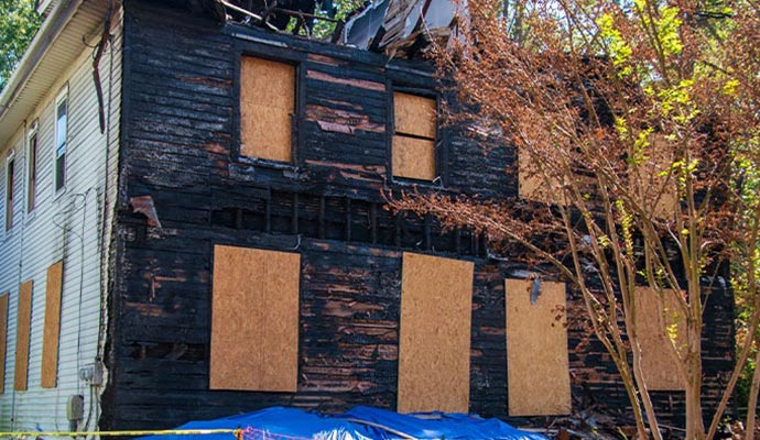 Boarded-up fire damaged residential house