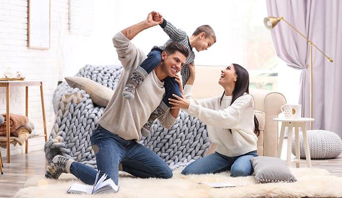 Happy family playing together in living room