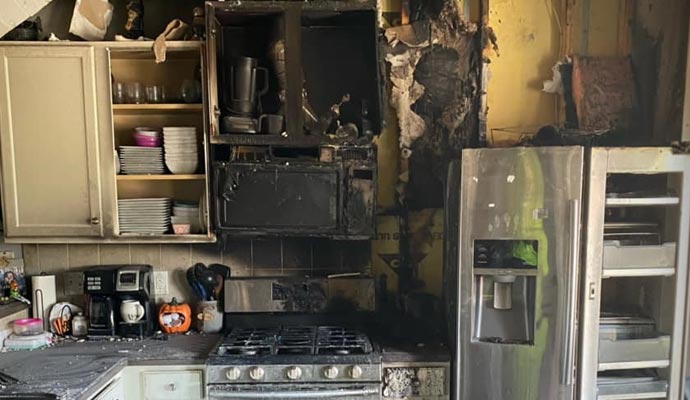 A kitchen severely damaged by fire